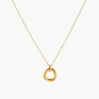 Delicate gold-plated necklace with three interlocking circle rings forming a minimalist knot pendant on cream background