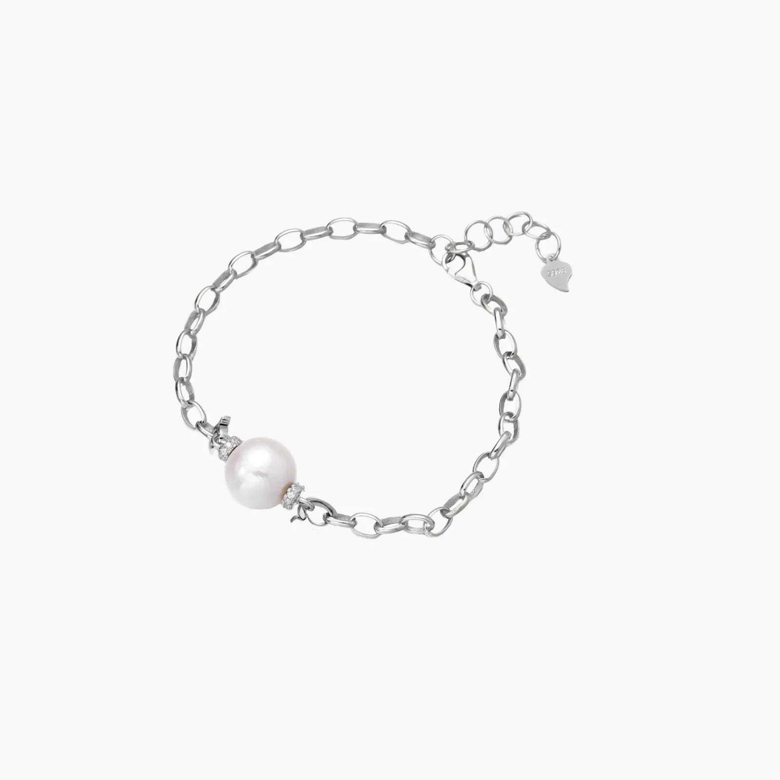 Rhodium-plated silver chain bracelet with single white freshwater pearl and heart charm clasp on cream background