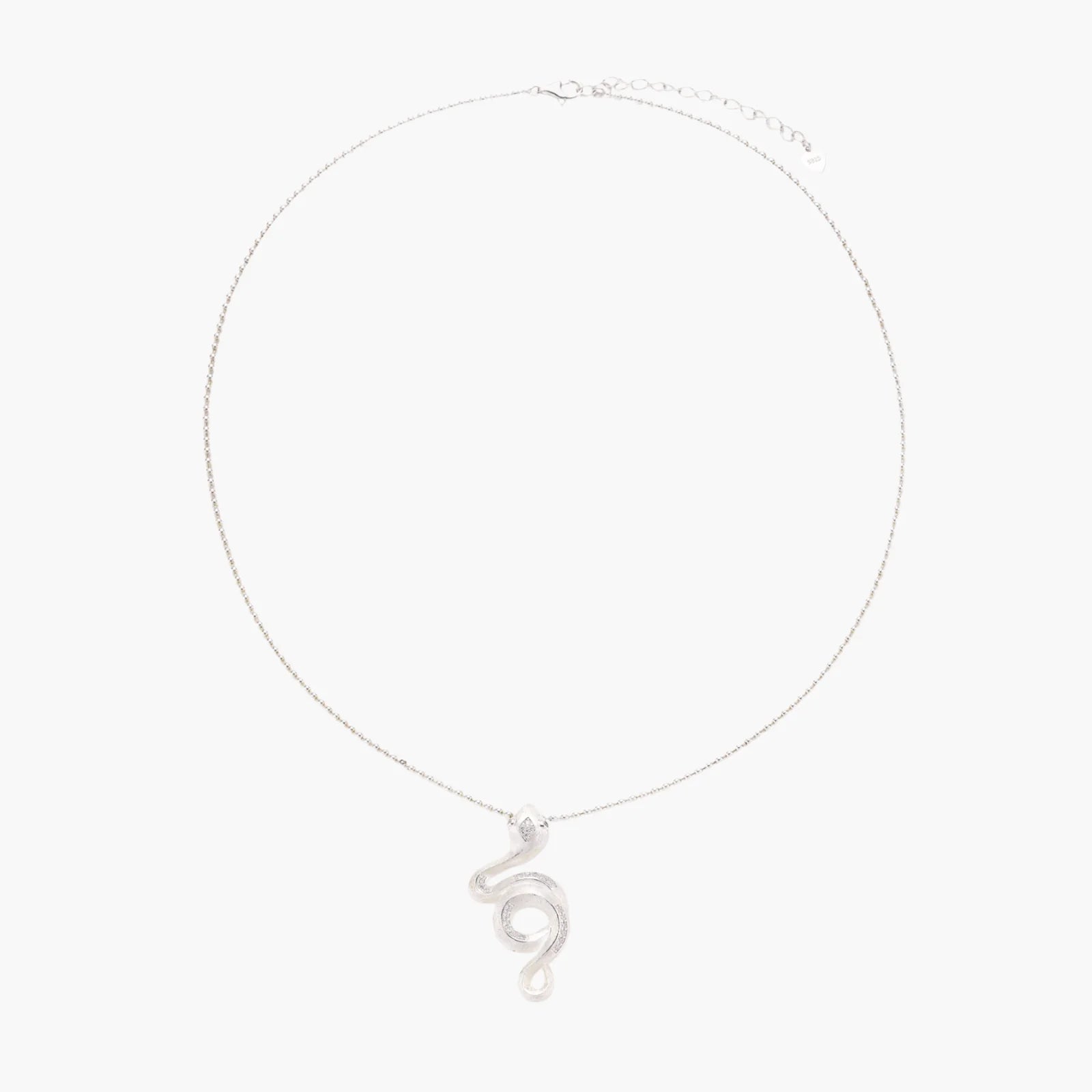 Abstract S-curve sterling silver pendant with zirconia accents on delicate chain against white background