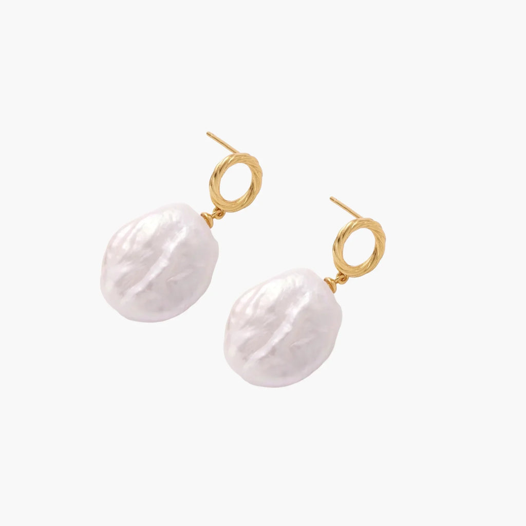 18K gold vermeil twisted circle studs with organic white baroque pearl drops on cream background