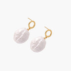 18K gold vermeil twisted circle studs with organic white baroque pearl drops on cream background