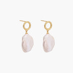 18K gold vermeil twisted circle studs with organic white baroque pearl drops on cream background