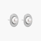 Oval rhodium-plated silver studs featuring freshwater pearls surrounded by pavÃ© crystal halo on white background