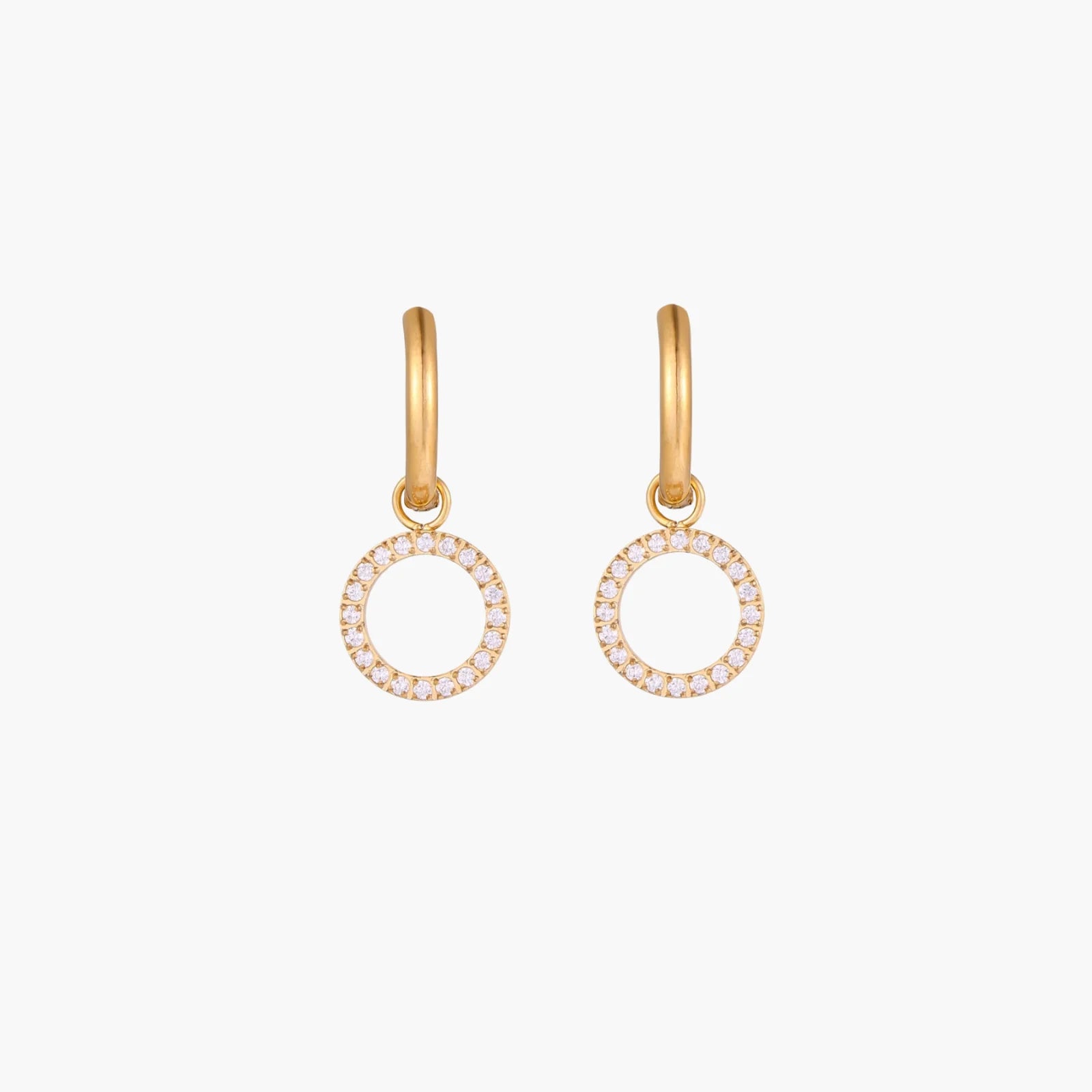 Gold-plated huggie hoop earrings with CZ-studded open circle charms on beige background