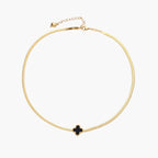 Dainty 18K gold-plated herringbone chain necklace with black enamel quatrefoil clover pendant on white background