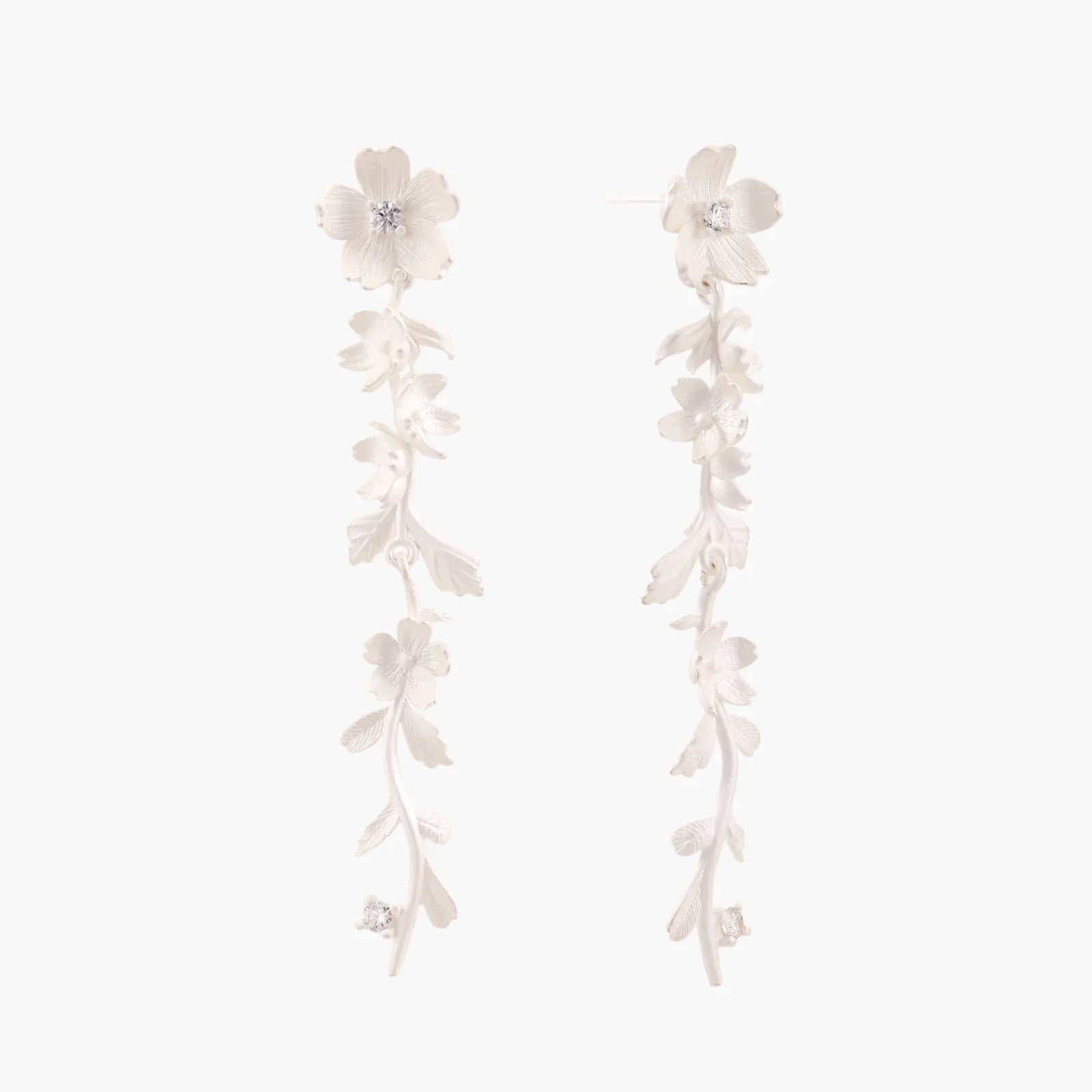 Long sterling silver drop earrings with delicate floral vine design and crystal accents on white background