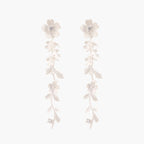 Long sterling silver drop earrings with delicate floral vine design and crystal accents on white background