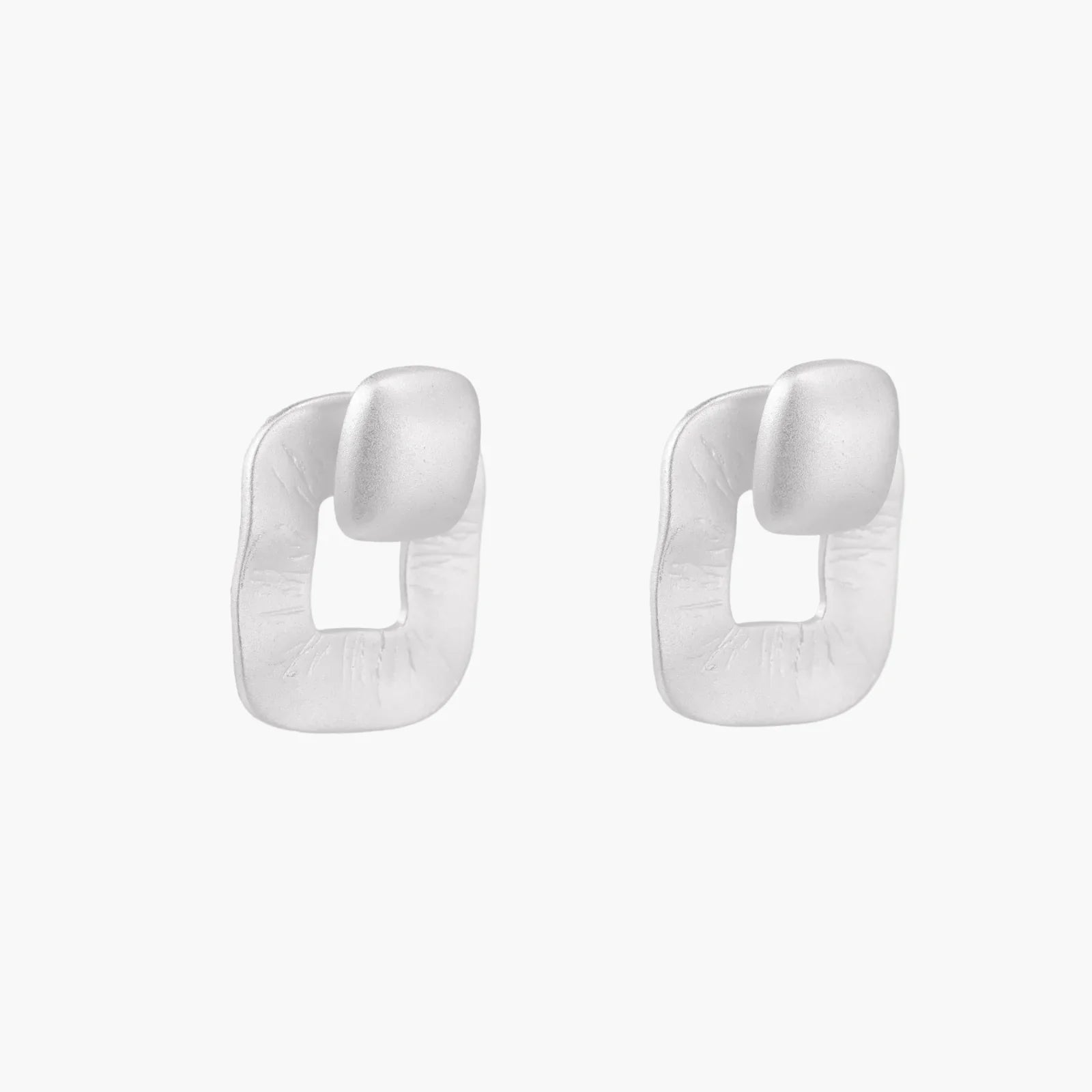 Pair of geometric sterling silver earrings with frosted square frames and glossy rounded studs on white background