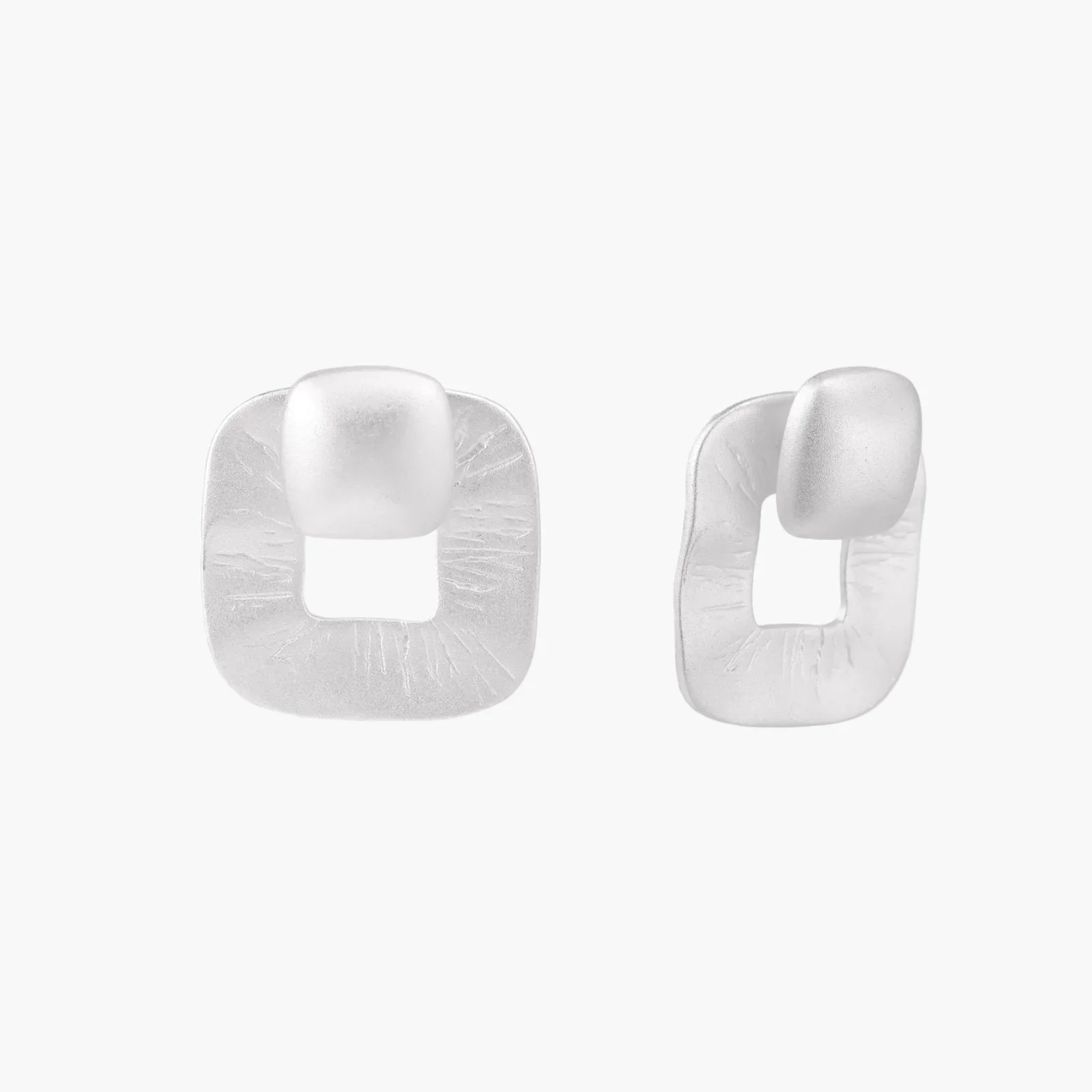 Pair of geometric sterling silver earrings with frosted square frames and glossy rounded studs on white background