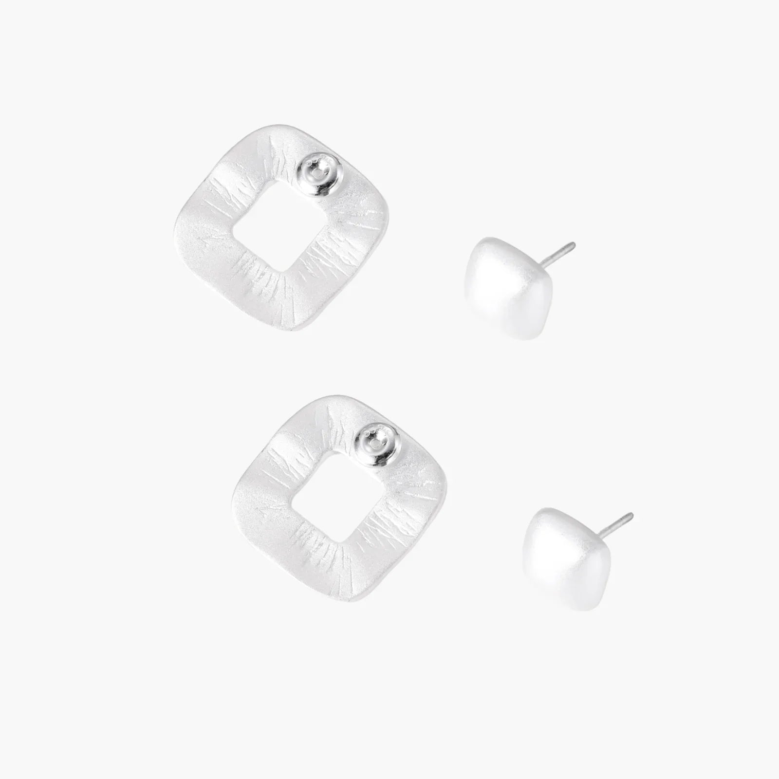 Pair of geometric sterling silver earrings with frosted square frames and glossy rounded studs on white background