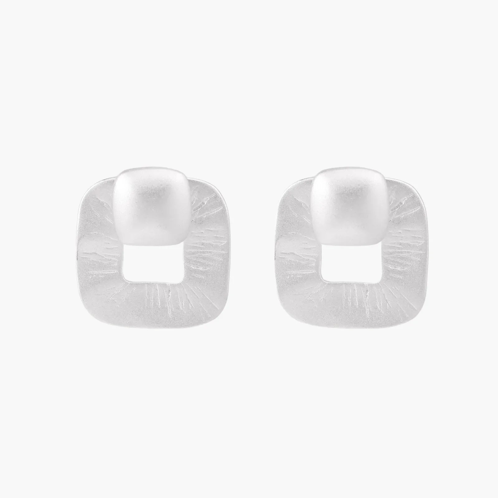 Pair of geometric sterling silver earrings with frosted square frames and glossy rounded studs on white background