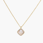 Gold quatrefoil pendant with crystal center on iridescent mother-of-pearl base, adjustable gold chain on cream background