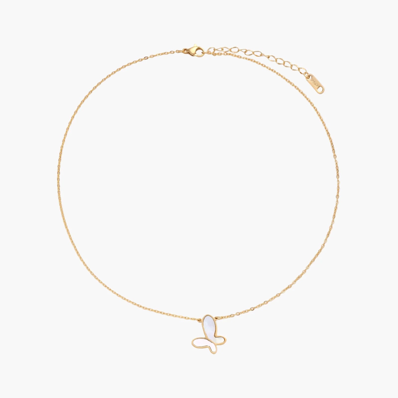 Gold-plated butterfly pendant with iridescent mother of pearl inlay on delicate chain against cream background.