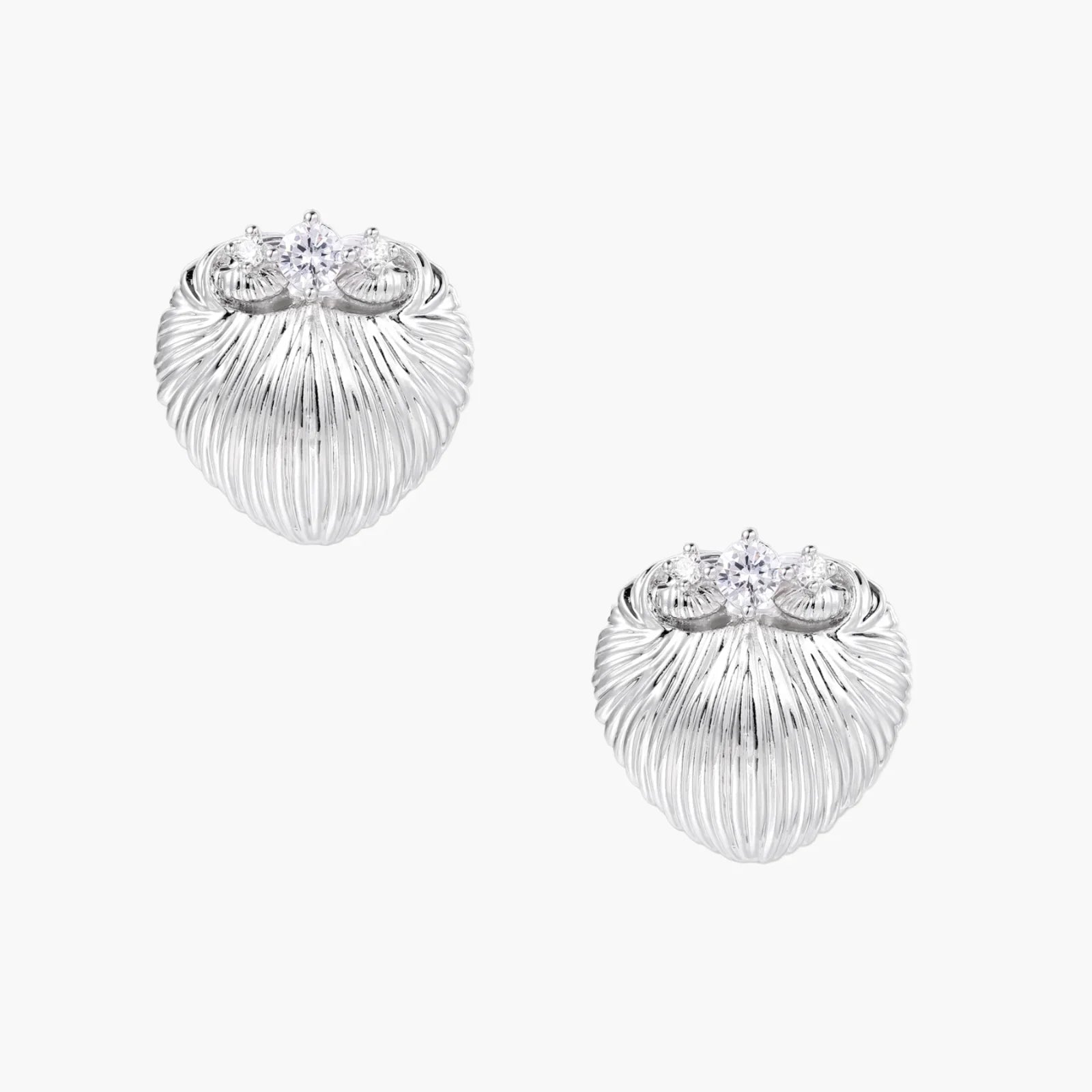 White gold-plated shell-textured stud earrings with three zirconia crystals on ridged surface against cream background.