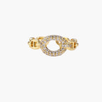 Gold-plated brass chain link ring with one oval CZ-pavÃ© segment on cream background, adjustable cuff style.