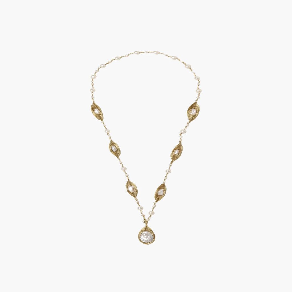 14K gold-plated necklace with eye-shaped stations and baroque pearl pendant on cream background
