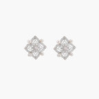 Ornate sterling silver stud earrings with mandala-inspired filigree pattern and four freshwater pearls on beige background