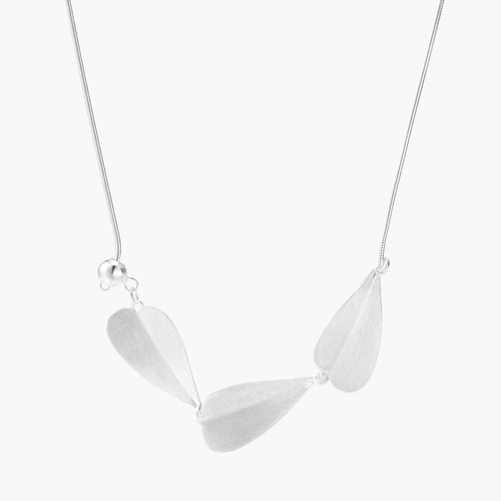 Minimalist sterling silver necklace with three brushed leaf-shaped pendants on delicate chain against white background
