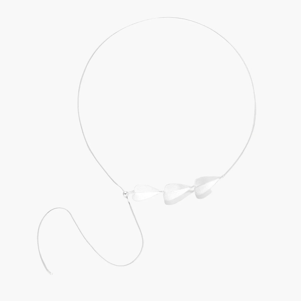 Minimalist sterling silver necklace with three brushed leaf-shaped pendants on delicate chain against white background