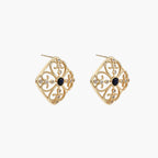 Gold filigree stud earrings with navy lapis lazuli center stone and mother-of-pearl accents in ornate quatrefoil design