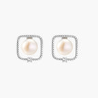 Rhodium-plated silver stud earrings with cushion frame, centered freshwater pearl, and tiny crystal accent