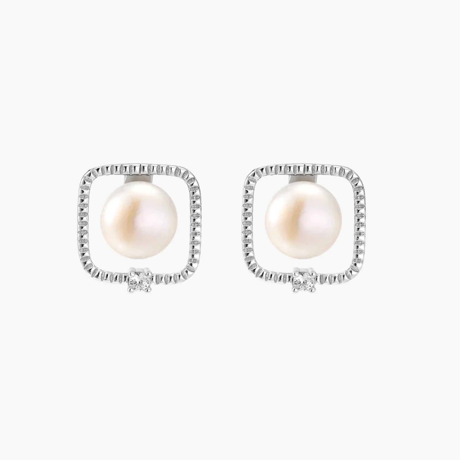 Rhodium-plated silver stud earrings with cushion frame, centered freshwater pearl, and tiny crystal accent