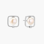Rhodium-plated silver stud earrings with cushion frame, centered freshwater pearl, and tiny crystal accent