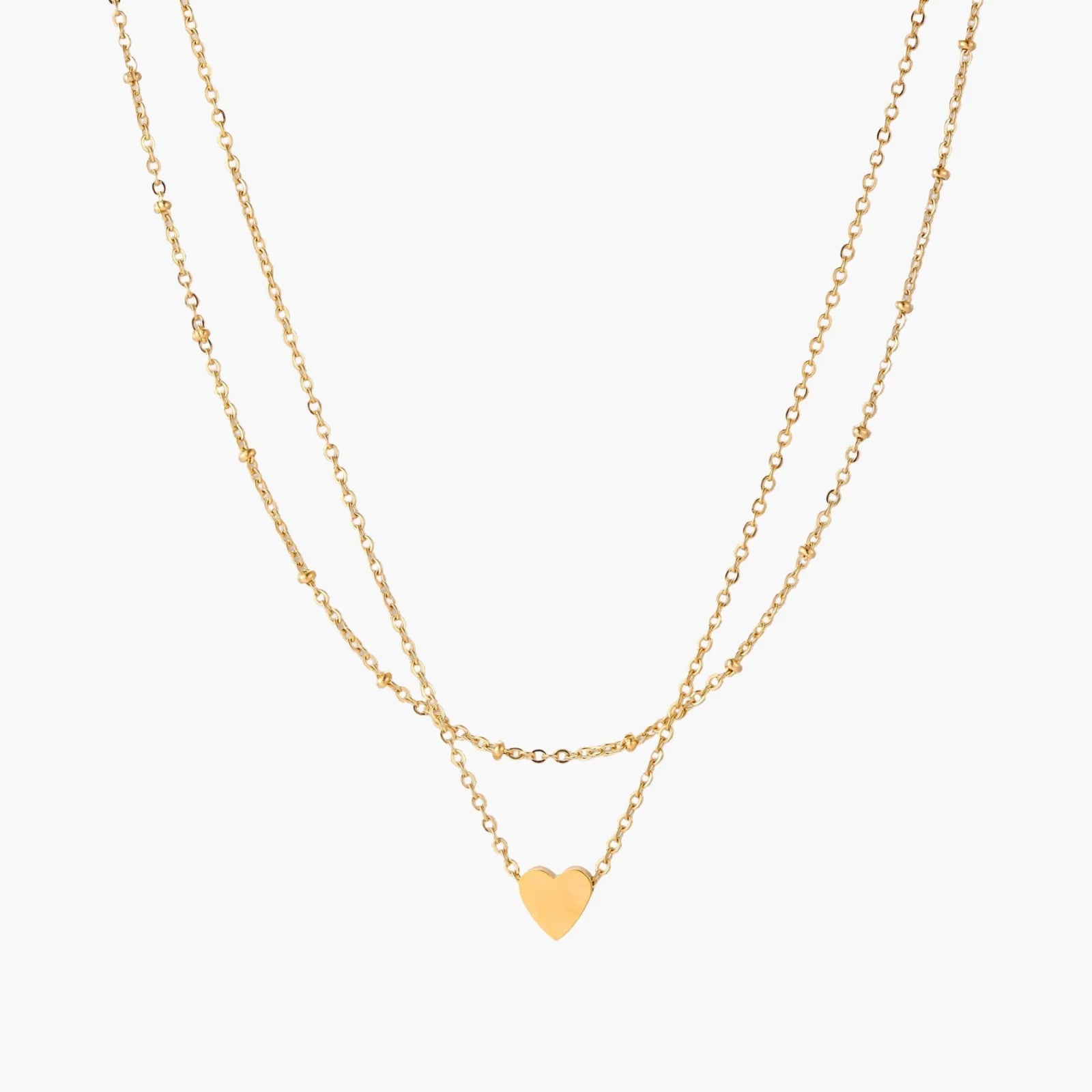 Delicate double-chain gold necklace with tiny heart pendant on cream background