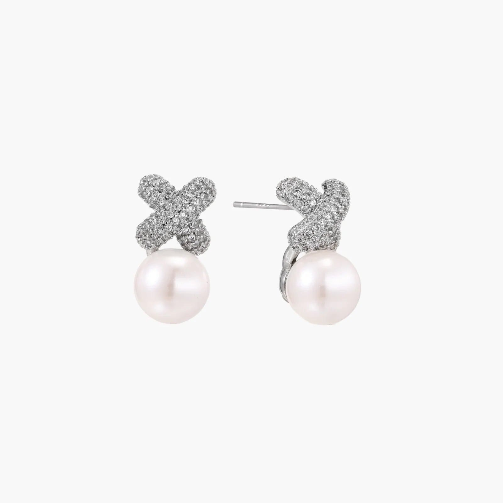 White gold plated studs featuring pavÃ© X-shaped tops with freshwater pearl drops on cream background.