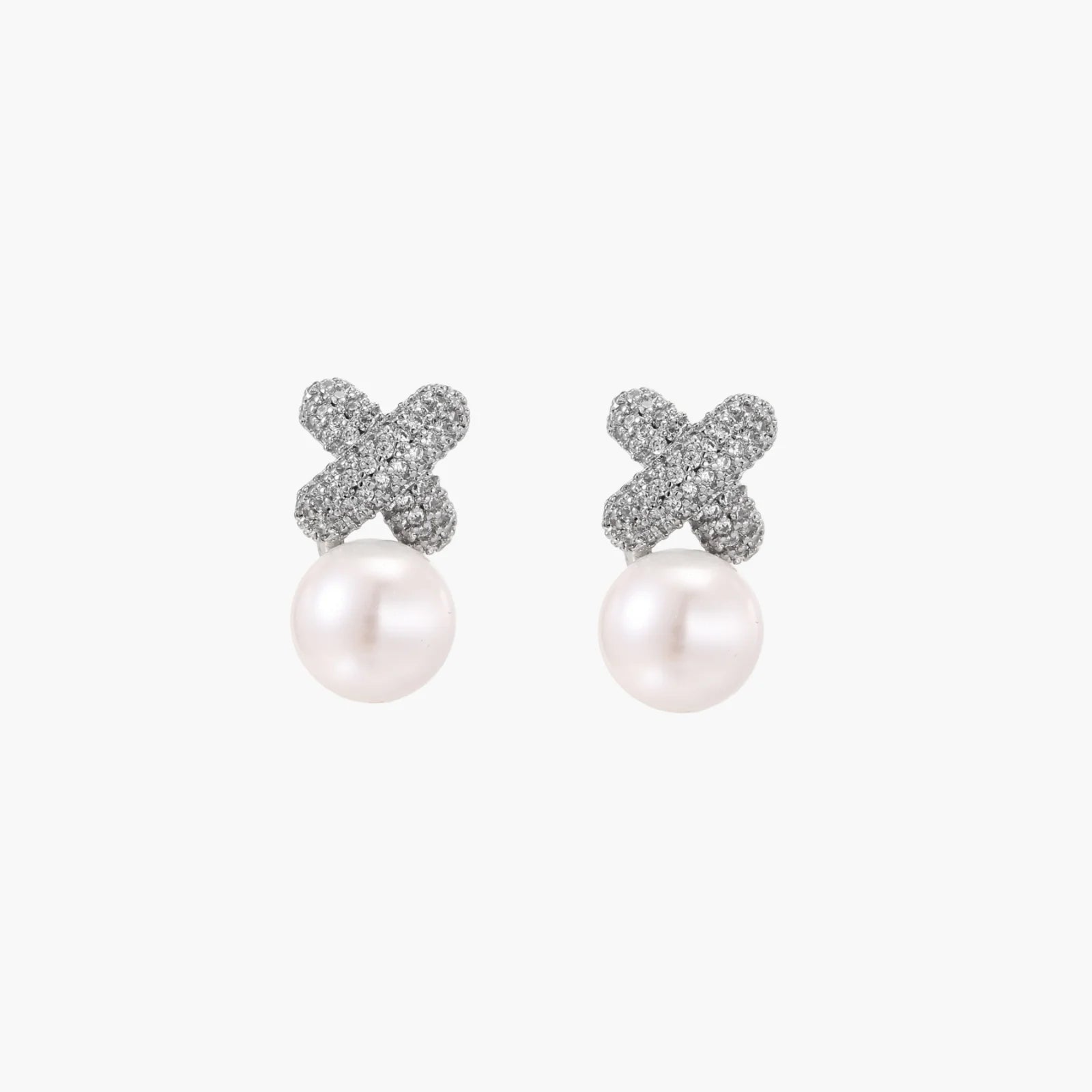 White gold plated studs featuring pavÃ© X-shaped tops with freshwater pearl drops on cream background.