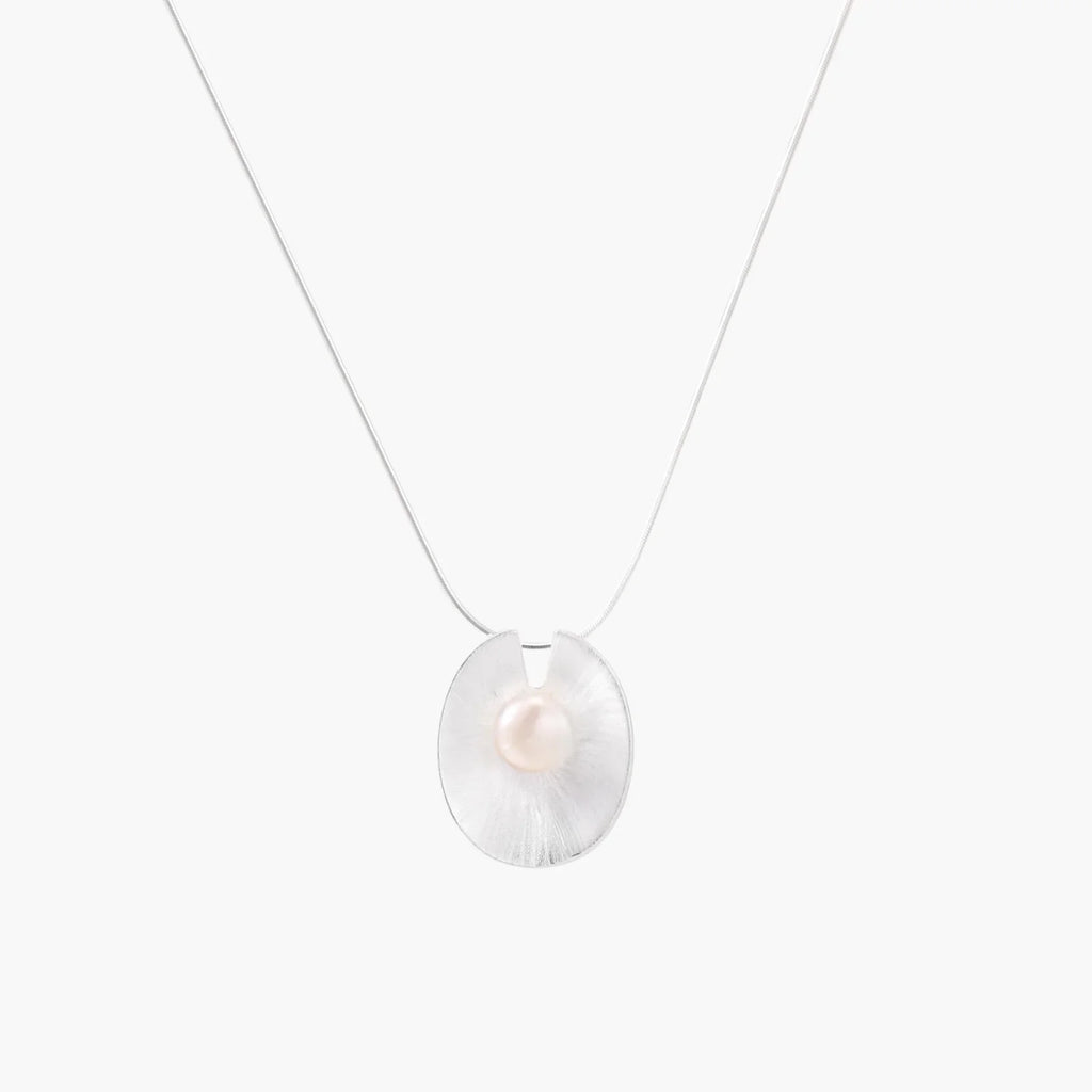 Sterling silver disc necklace with textured finish and centered freshwater pearl on delicate chain