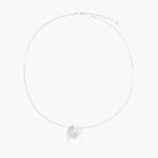 Sterling silver disc necklace with textured finish and centered freshwater pearl on delicate chain