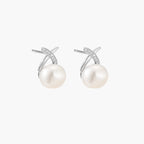 Rhodium-plated silver stud earrings with sparkling X design above lustrous round freshwater pearls on white background.