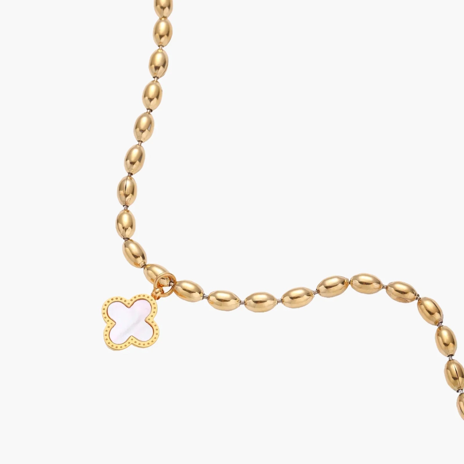 18K gold-plated oval bead chain bracelet with quatrefoil clover charm featuring mother of pearl inlay on cream background
