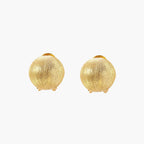 Pair of brushed gold dome earrings with clip backs showing textured matte finish on cream background