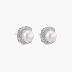 Cushion-shaped sterling silver stud earrings with freshwater pearls surrounded by geometric diamond halos