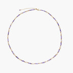 Delicate 18K gold vermeil necklace with alternating lavender zirconia beads and white freshwater pearls on cream background
