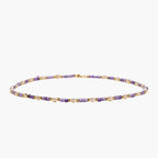 Delicate 18K gold vermeil necklace with alternating lavender zirconia beads and white freshwater pearls on cream background