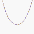 Delicate 18K gold vermeil necklace with alternating lavender zirconia beads and white freshwater pearls on cream background