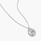 Sterling silver necklace featuring a large pear-shaped moissanite stone in an ornate setting with smaller accent stones