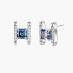 Square moissanite studs in sterling silver geometric setting showing rainbow prismatic fire on white background.