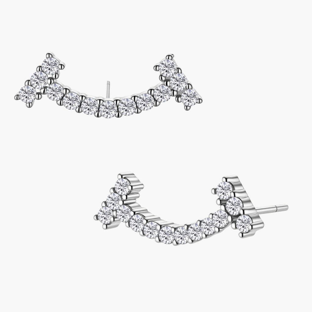 Curved sterling silver ear climbers with moissanite stones arranged in elegant arc shape on white background
