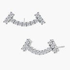 Curved sterling silver ear climbers with moissanite stones arranged in elegant arc shape on white background